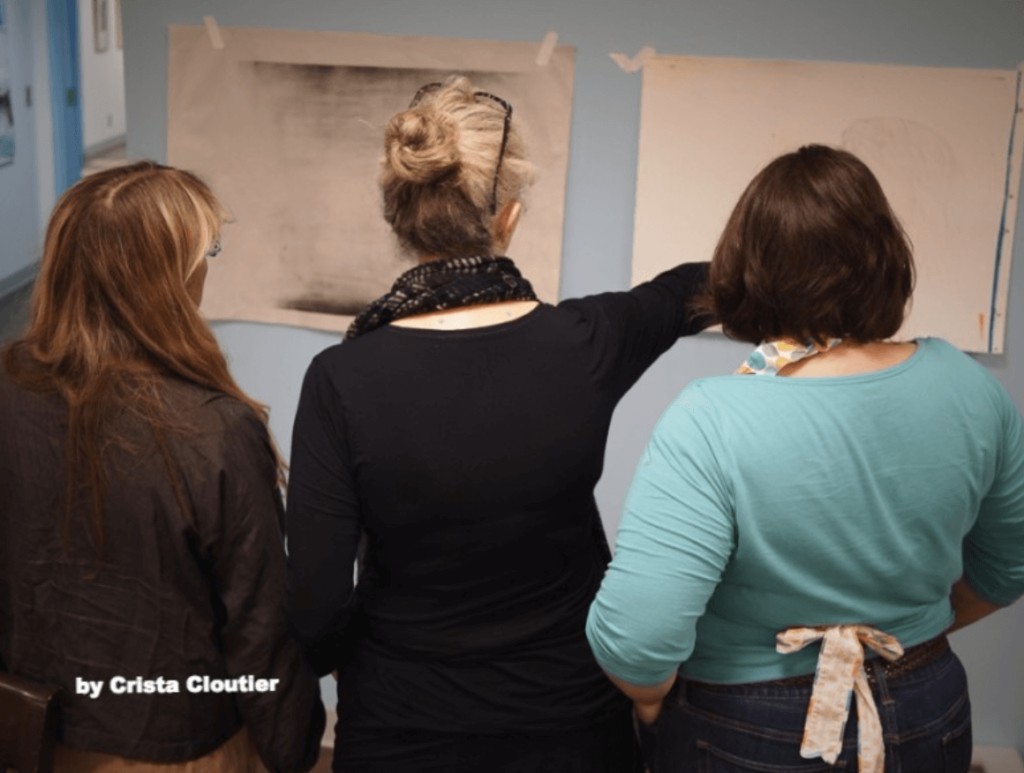 3 women critiquing artwork